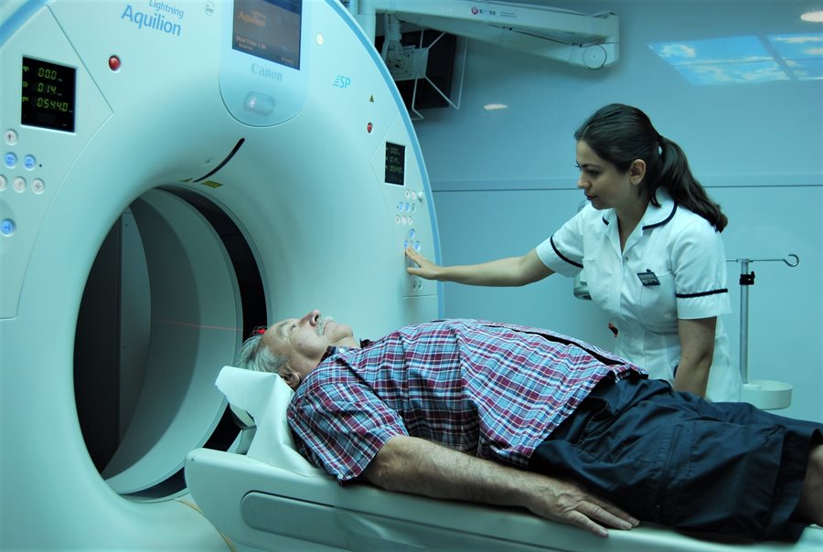 Patient Peter West has a CT scan at a mobile unit being used in advance of the new build.